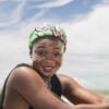 Happy Africa Woman with headdress from Ghana on a beach on the coast of Axim Ghana West Africa